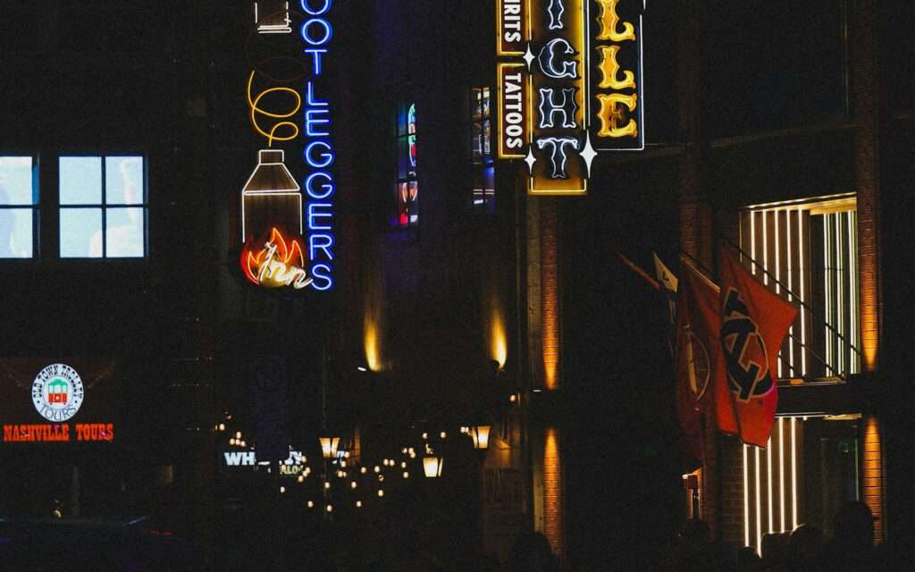 Neon honky-tonk signs glowing at night in Nashville