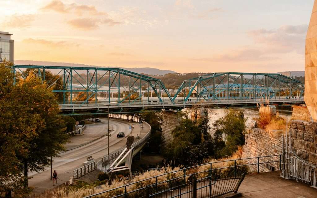 The blue truss spans of the Walnut Street pedestrian bridge in Chattanooga at sunset